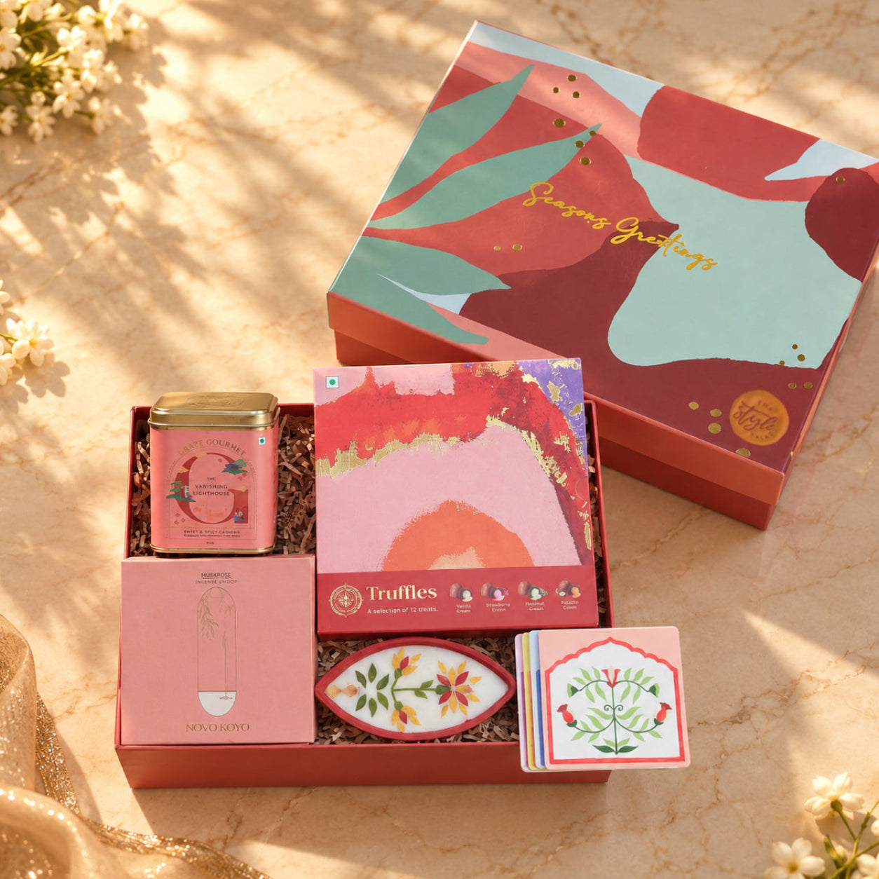 Ruby Rush Diwali gift hamper with chocolate truffles, flower pressed boat diya, marigold seed kit, coasters and incense