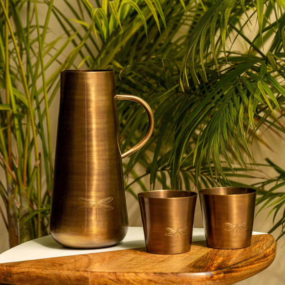 Handcrafted Jugnu brass jug and two matching tumblers with elegant firefly motif.
