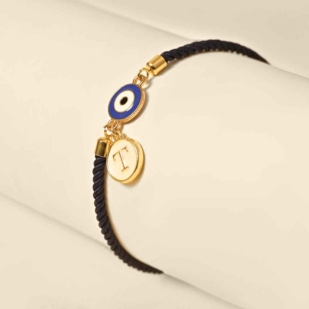 Personalized Evil Eye Initial Rakhi with custom initial and premium thread for Raksha Bandhan, now available at The Style Salad.