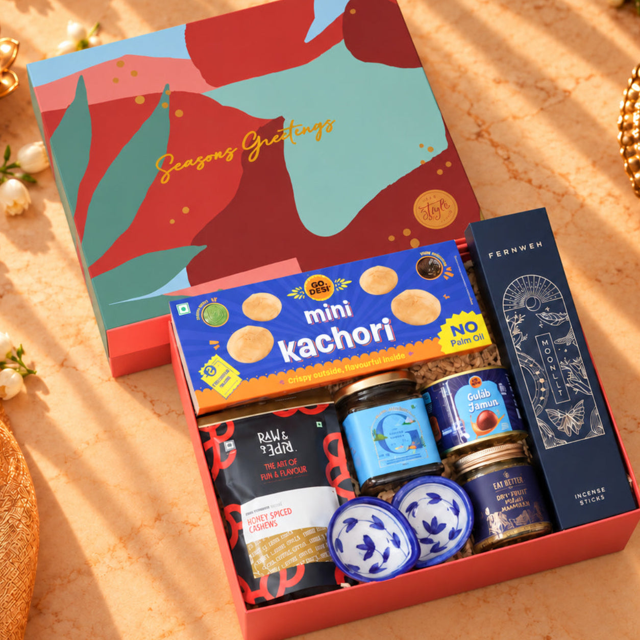 Blue Bijoux Diwali gift hamper with Ceylon Breeze honey, ceramic diyas, gulab jamun tin, millet namkeen, cashews and incense sticks