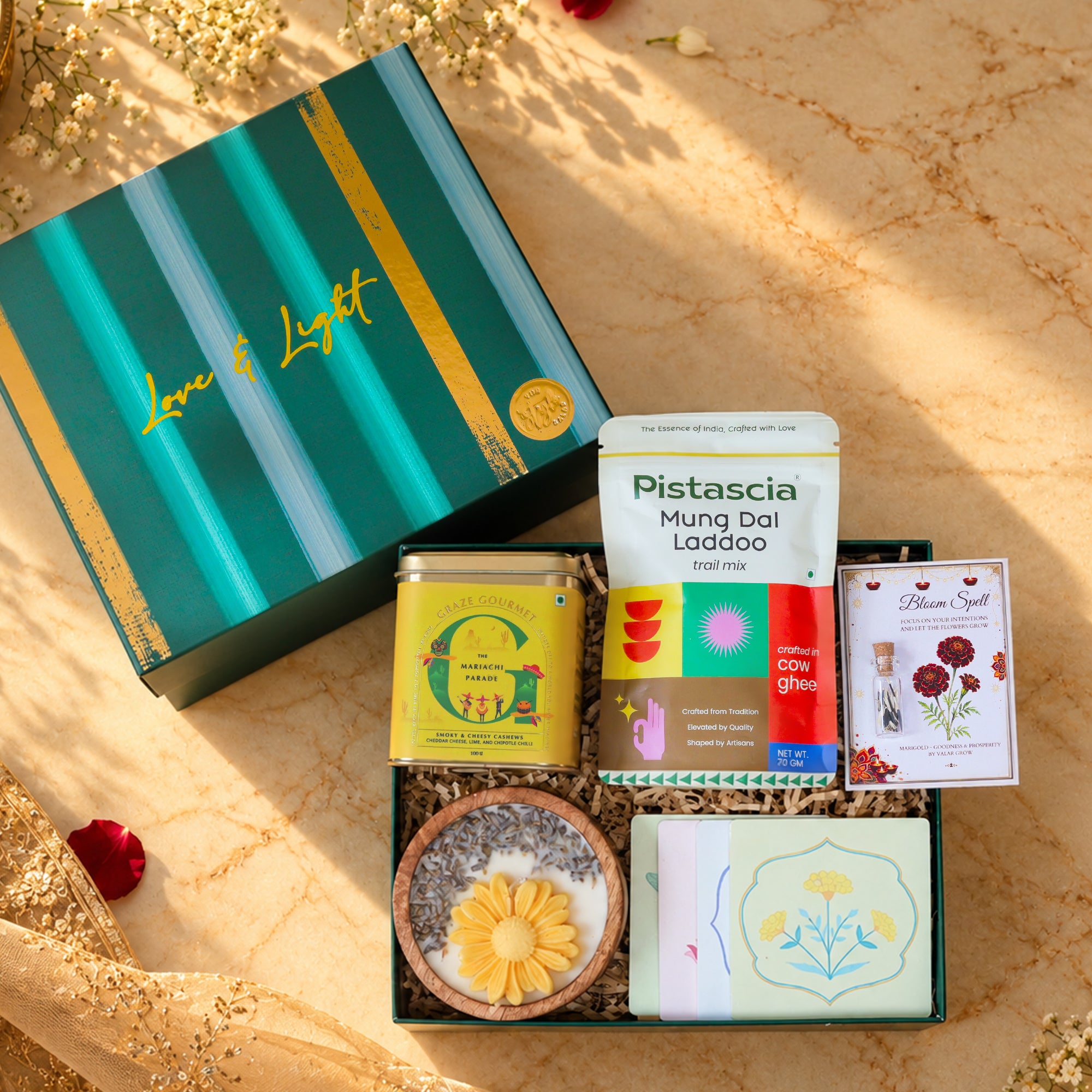 Marigold Magic Diwali gift hamper with floral handcrafted coasters, smoky cheesy cashews, marigold seeds, trail mix and lavender soy candle