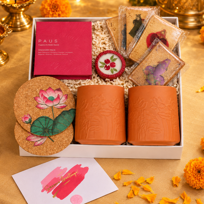 KAMAL DEEP festive gift hamper with almond strawberry biscuits, lotus cork coasters, flower-pressed terracotta diya and elegant drinkware