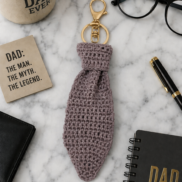 Handmade grey crochet Father's Day tie keychain with a detailed necktie design and keyring attachment. A lightweight and thoughtful keepsake gift for Dad, perfect for keys, bags, gift hampers, and Father's Day celebrations.