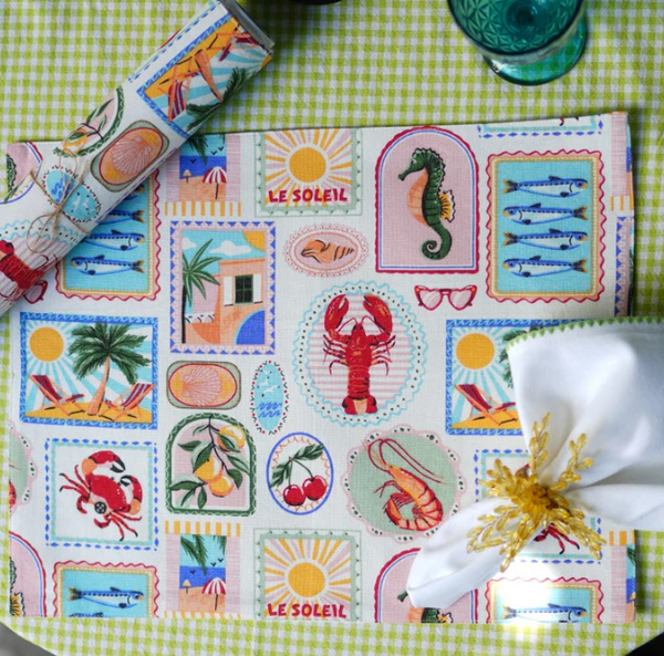 Colorful placemat with beach-themed designs on a green checkered tablecloth.