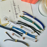 Hamsa Rakhi with Initial | Assorted Thread Colour