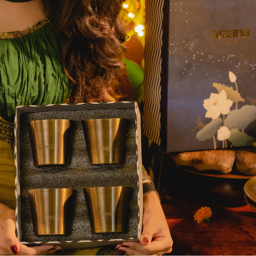 Jugnu Set of 4 handcrafted brass tumblers with a polished golden finish.