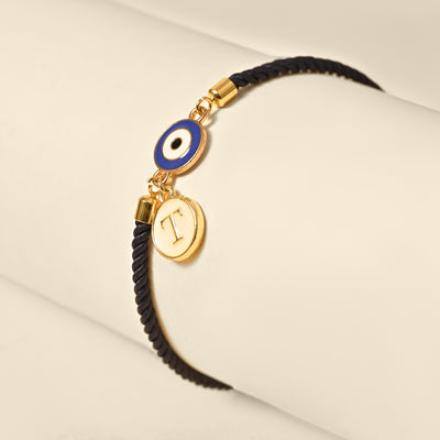 Personalized Evil Eye Initial Rakhi with custom initial and premium thread for Raksha Bandhan, now available at The Style Salad.